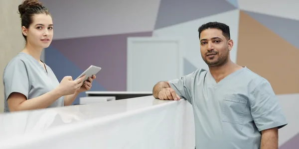 Equipe de saúde uniformizada na recepção de uma clínica moderna
