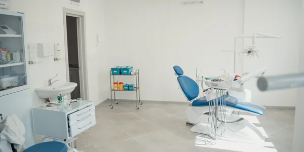 Bright and clean dental clinic interior showcasing a dental chair and equipment.