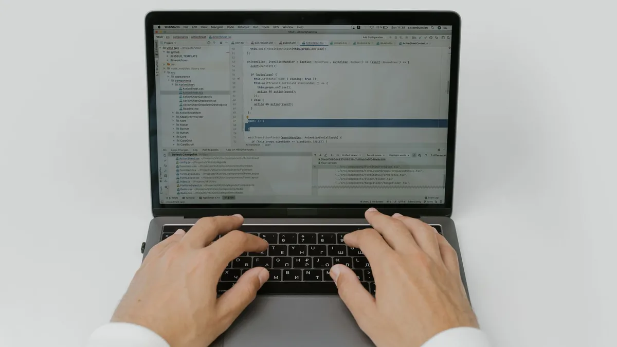 Mãos digitando código no teclado de um notebook